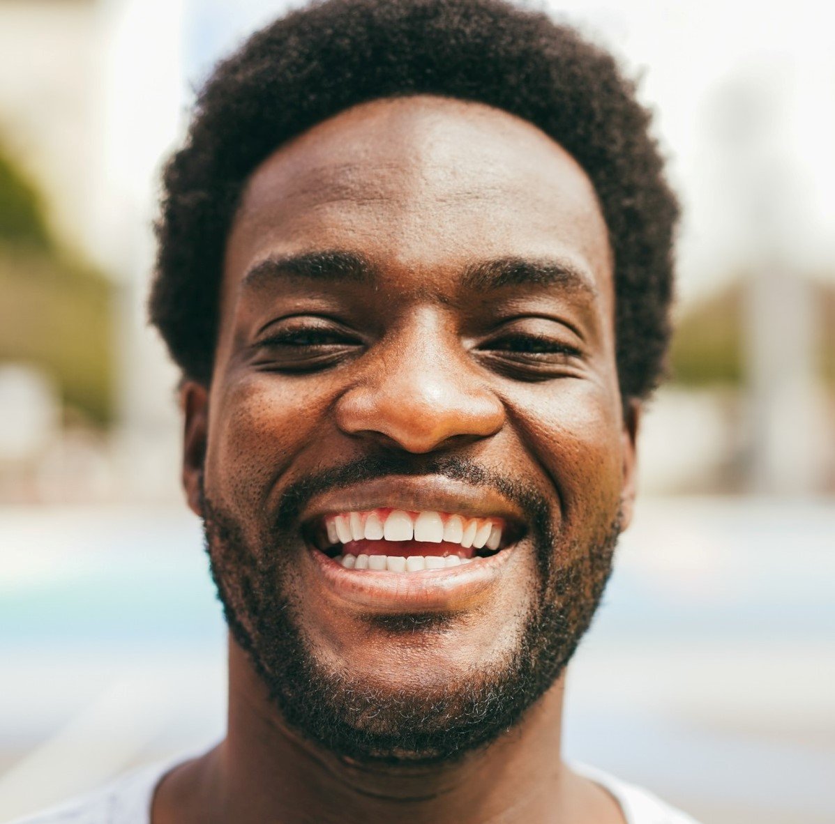 Testimonials happy african man smiling at camera inside ba.jpg